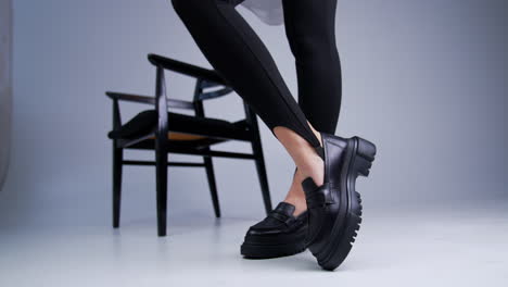 stylish black platform loafers on woman