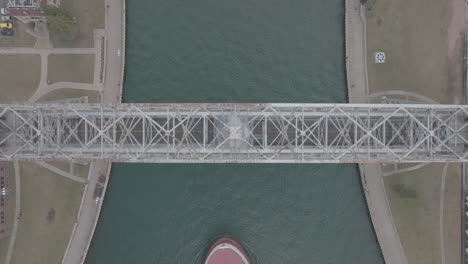 cargo ship passing under duluth's aerial lift bridge in minnesota