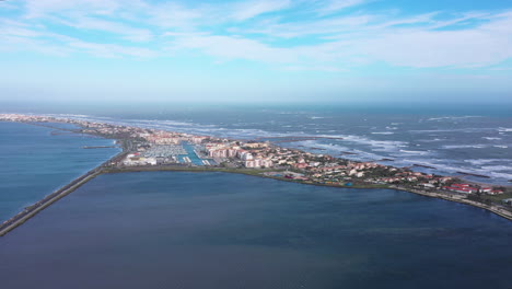 Aerial-back-traveling-windy-day-over-Frontignan-coastal-pond-and-mediterranean