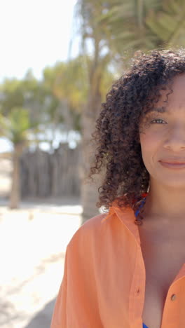vertical video of portrait of happy african american woman at beach house