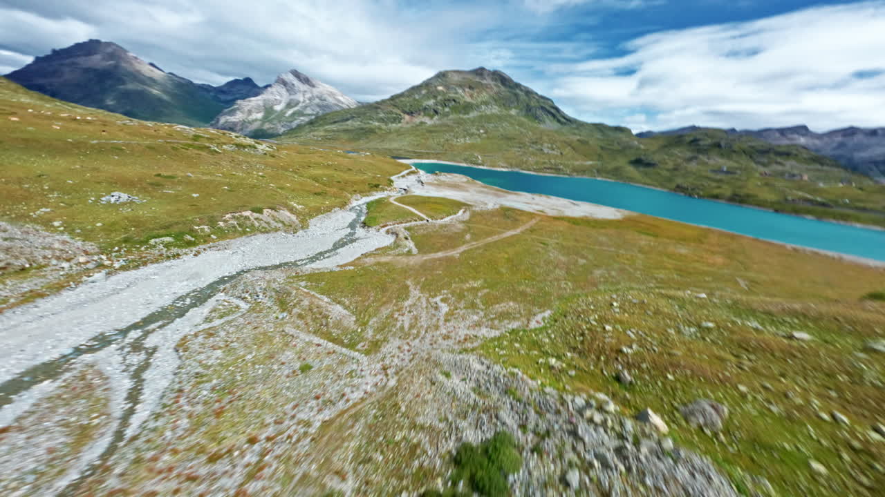 Aerial view of the Bernina Pass, serene landscape with mountain lake