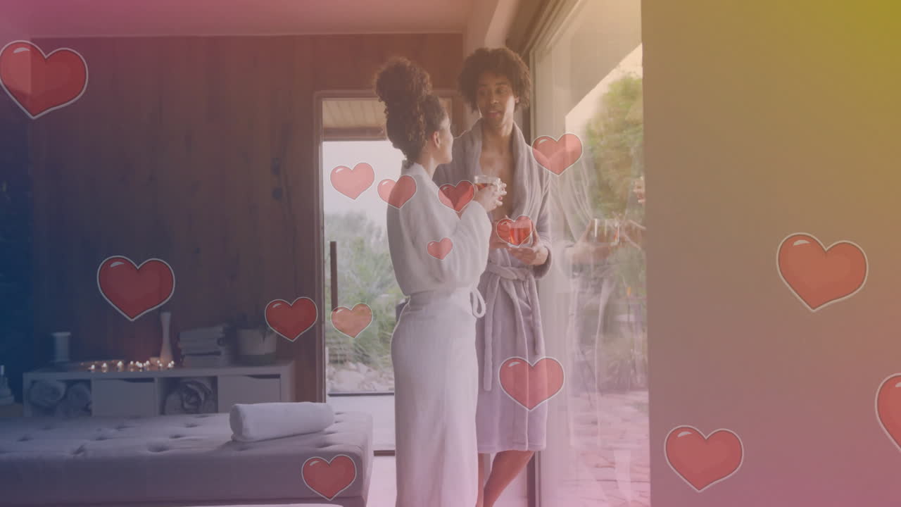 큰 창문 근처에서 대화하는 목욕복을 입은 두 여성의 심장 모양 애니메이션
