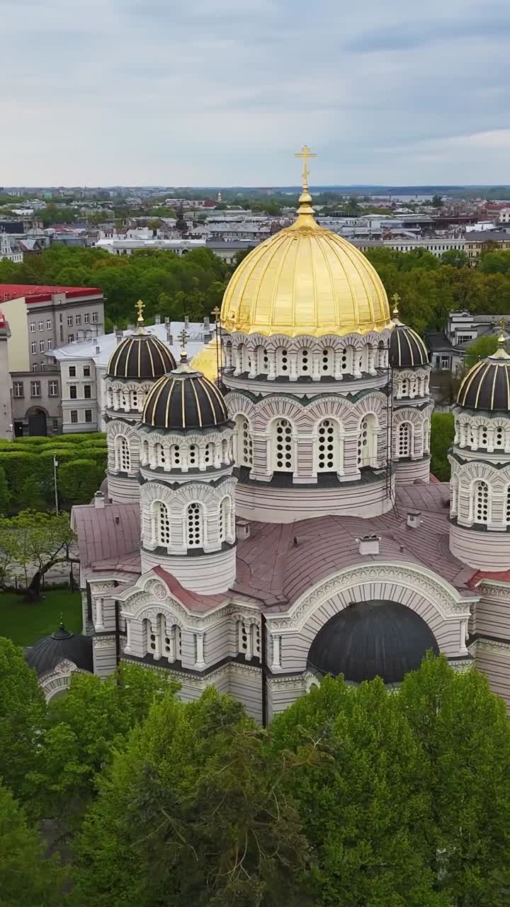 Front view of Nativity Cathedral in Riga with golden dome in aerial vertical video