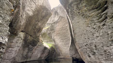 majestic rock formations in norway look like cave with water on floor