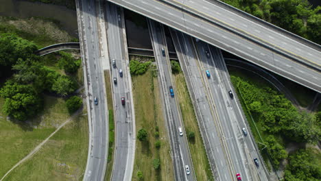 Aerial-view-overlooking-traffic-on-road-Autoroute-5,-in-sunny-Gatineau,-Canada