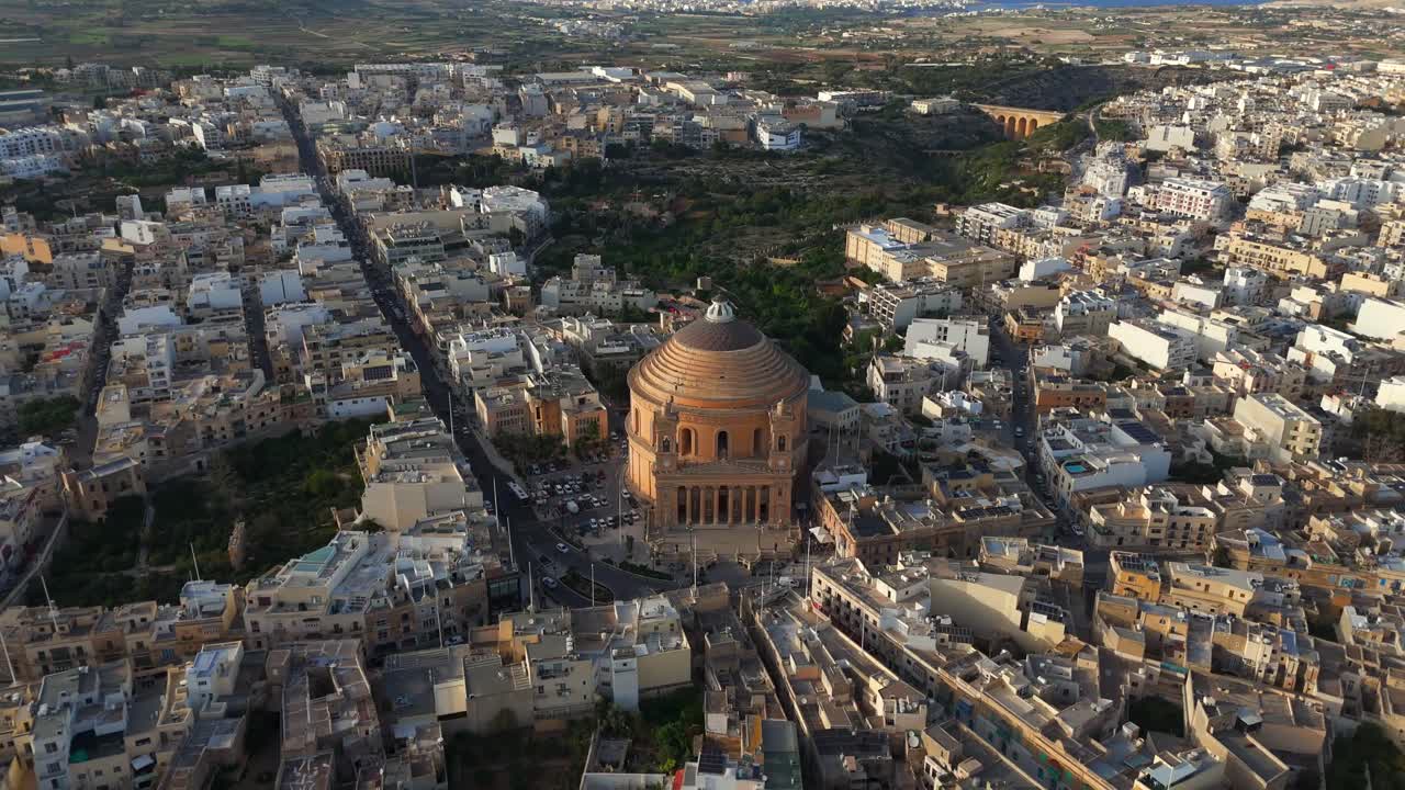 Soar over the majestic Mosta Church, capturing its historical significance and vibrant surroundings, as this drone video highlights Malta’s rich cultural heritage.