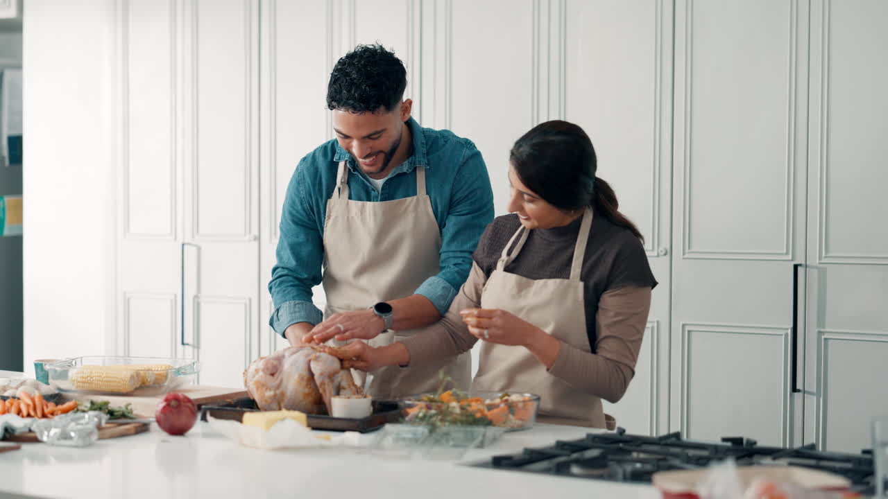 Couple preparing a turkey together in the kitchen