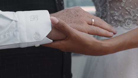 loving couple of bride and groom joins hands at wedding