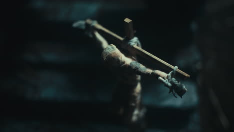 miniature mummified dolls hanging on the gallows at night