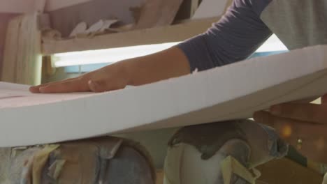 male surfboard maker in his workshop