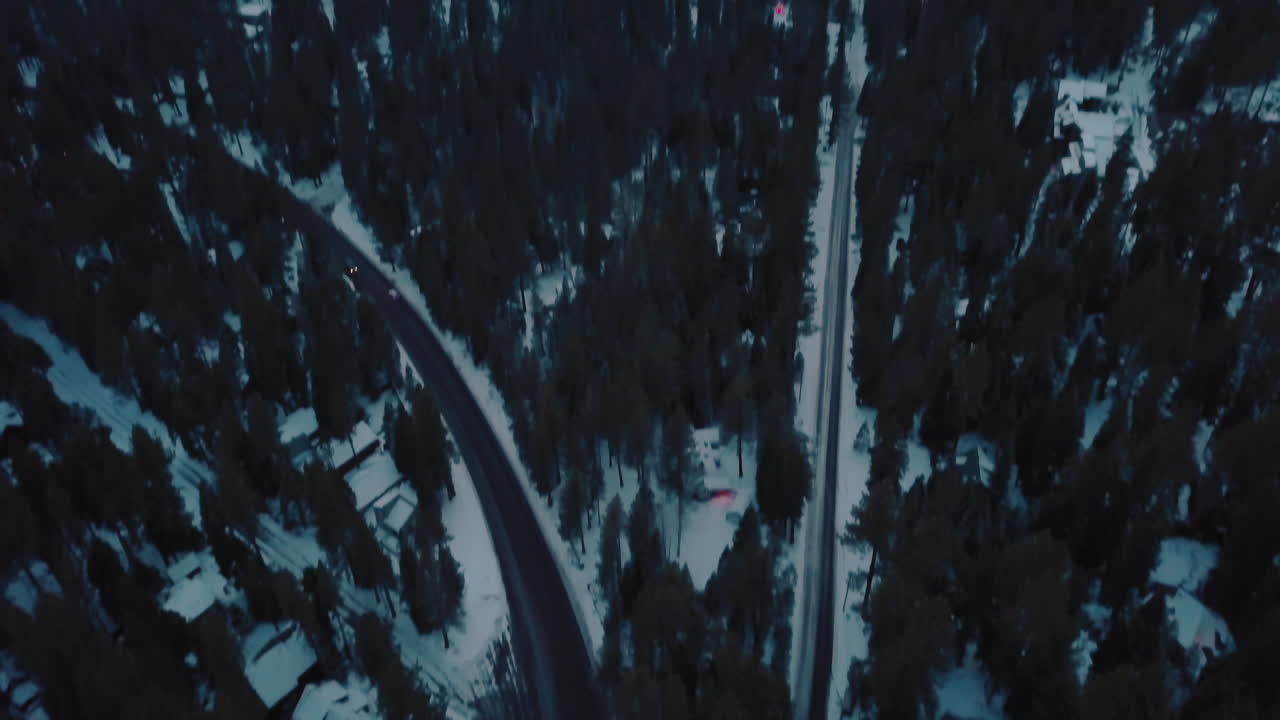 Drone shot of a snowy road in the evening near Lake Tahoe
