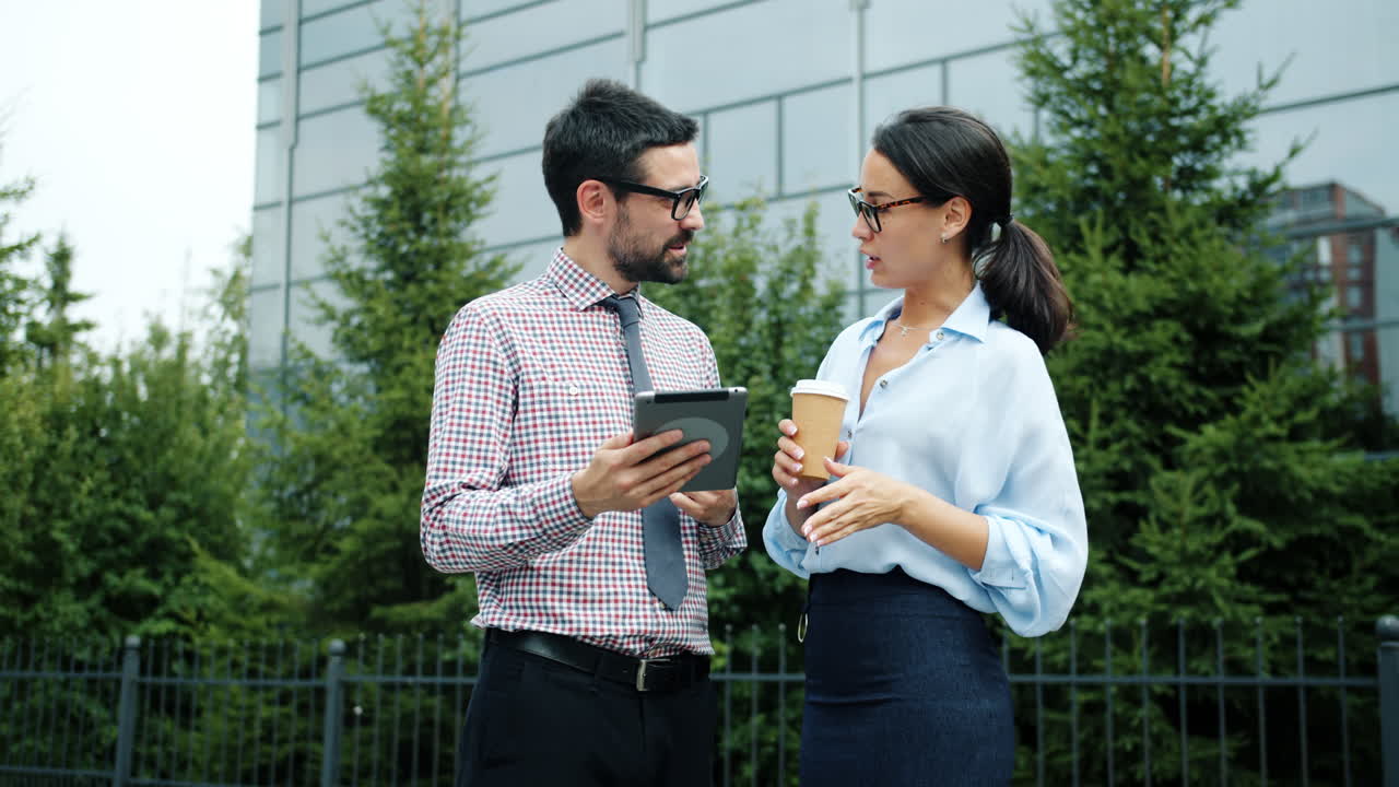 Business People Discussing Project Outdoors