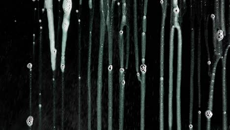 abstract soap suds and foam streaks on dark background