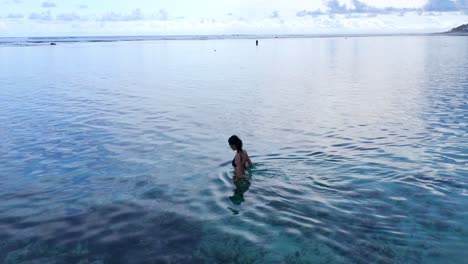 female tourist on secluded beach of gunung payung in bali, indonesia