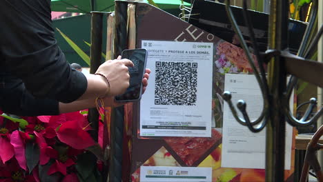 close up, person is scanning qr code at the entrance of a restaurant