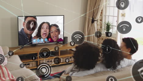 animation of media icons over biracial family having tv video call