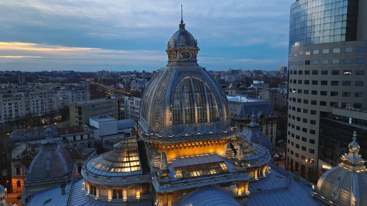 Aerial drone view of the illuminated dome of Palace of the Deposits and Consignments in the evening. Blue hour in Bucharest, Romania