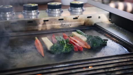 seasoning vegetables with salt and pepper on the grill