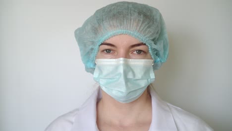 female doctor puts on a mask. close-up