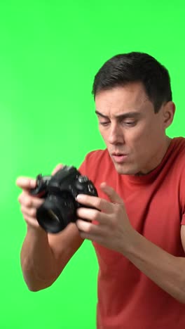 man with camera on green screen