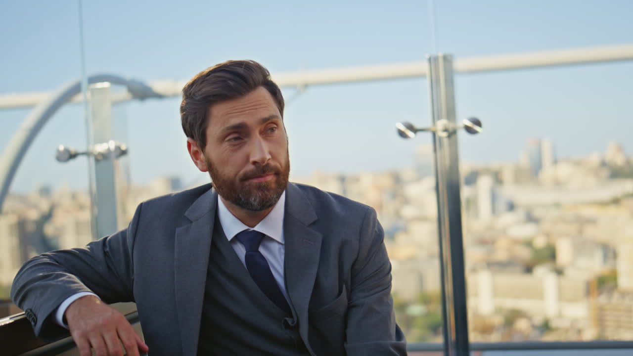 Rich man using laptop on terrace closeup. Handsome professional drinking coffee