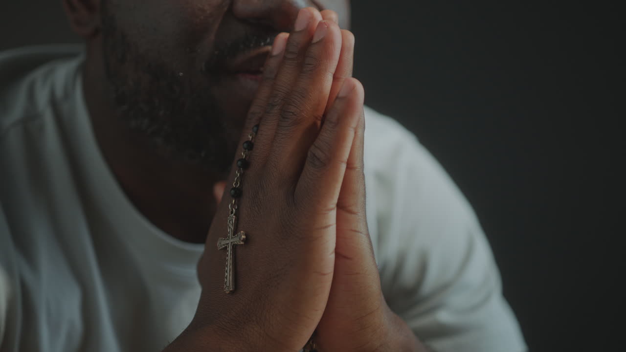 Religious Black Man Holding Cross and Praying to God
