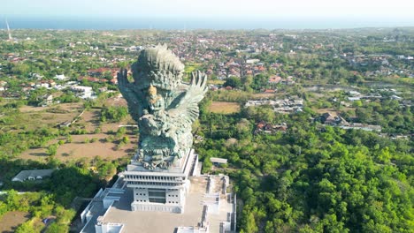 aerial of bali's patung garuda wisnu kencana, awe-inspiring statue that depicts the hindu god vishnu riding atop the mythical bird garuda