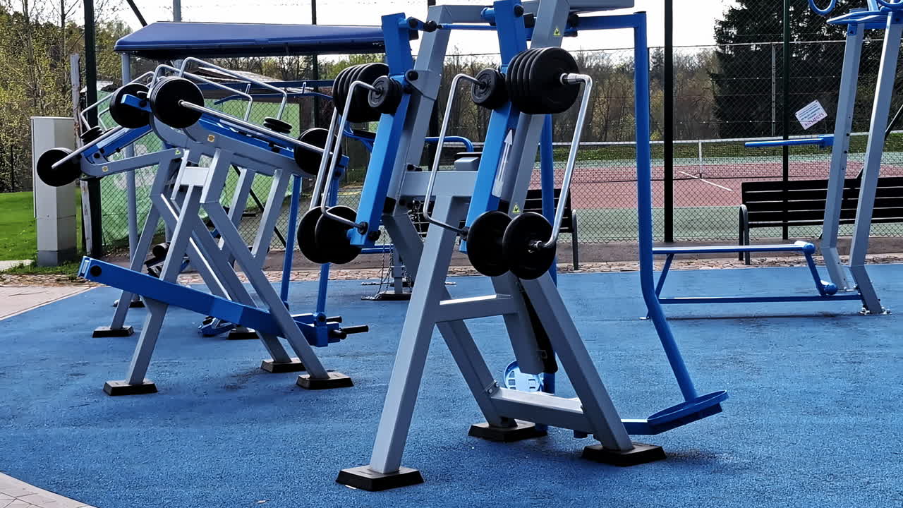 Outdoor gym with weight training machines on blue flooring