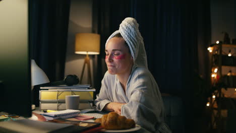 closeup freelancer working computer late at night. smart bathrobe woman smiling