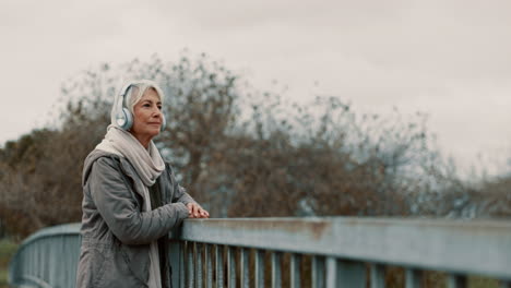 bridge, senior woman and headphones with music