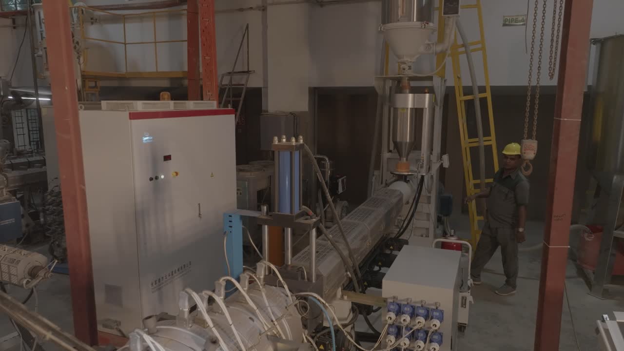 Aerial shot capturing all the machines present at PVC Pipe Making Factory in Karachi, Pakistan. Pakistani workers.