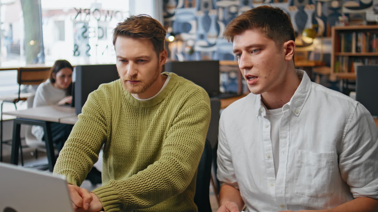 Focused colleagues staring computer screen at room. Closeup creative team work