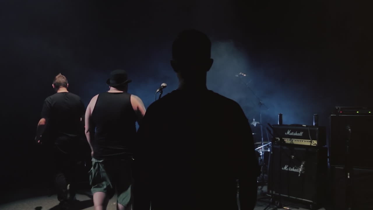 Silhouette of people at a concert backstage