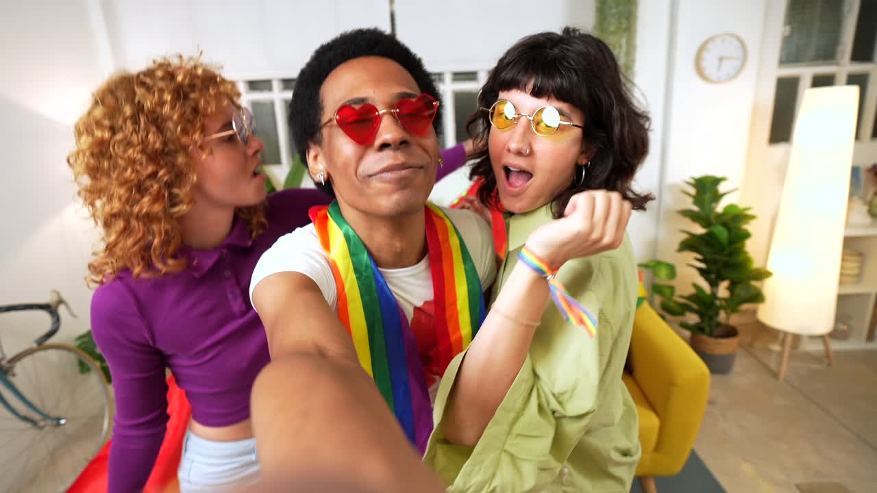 Friends taking selfie with rainbow flag at pride celebration
