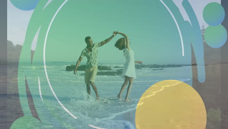 animation of colourful shapes over african american couple walking on beach