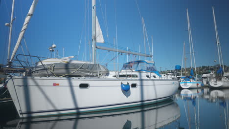 Close-up-slow-motion-shot-of-the-boat-on-a-calm-ocean-water-at-cruise-ship-terminals-at-Seattle,-WA-USA-on-a-sunny-day-with-many-boats-behind