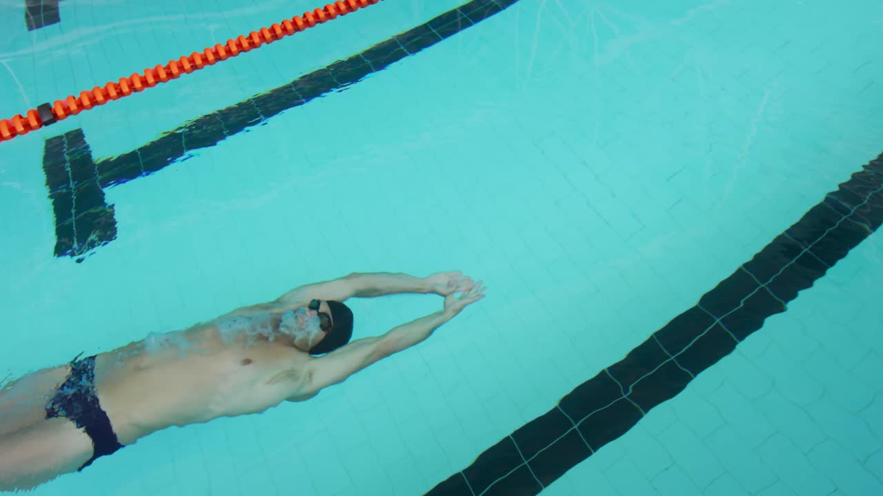 Swimmer swimming into the pool