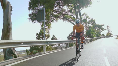 A-morning-scene-features-a-man-cycling-on-a-road-bike,-engaging-in-outdoor-exercise-on-a-quiet-road.-The-slow-motion-perspective-emphasizes-the-concept-of-extreme-sports
