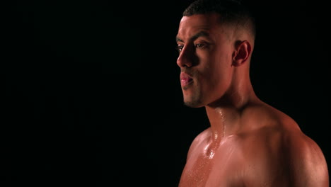 male bodybuilder drinking water from a bottle