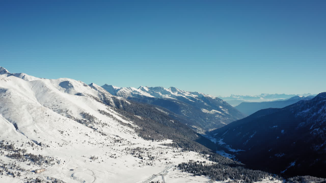 Cinematic Aerial View of Snowy Mountain Valley