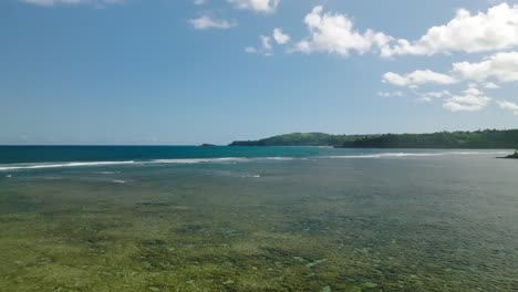 Wide-Aerial-Dolly-moving-forward-low-over-Anini-Beach,-Kauai,-Hawaii