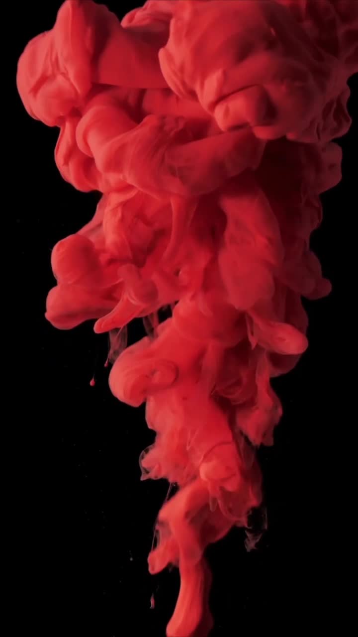 Vibrant Red Ink Dispersing in Water on Black Background