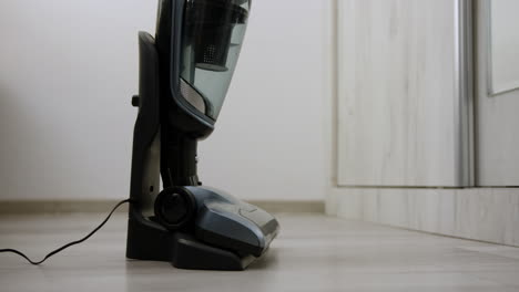 placing a vertical vacuum cleaner on its charging stand