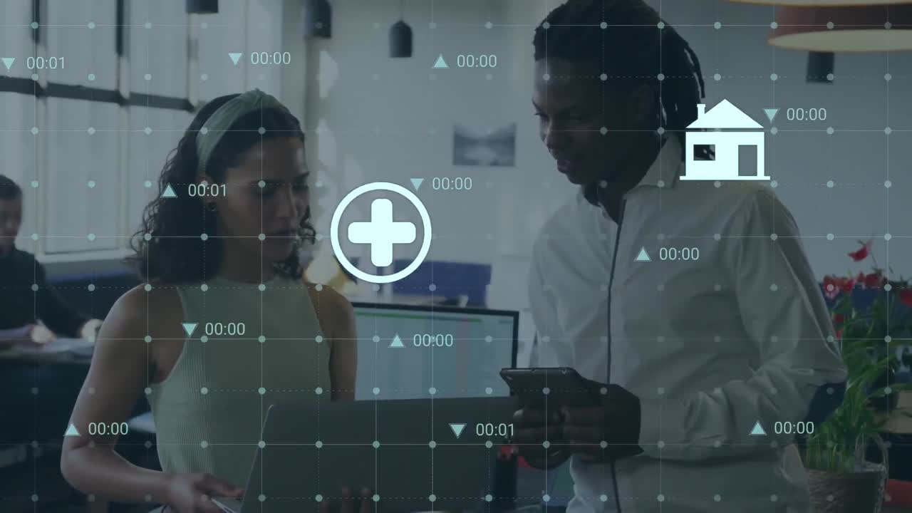 Animation of digital icons and data processing over diverse man and woman discussing at office