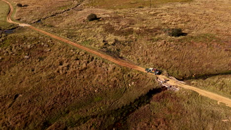 drone view of workers filling fire fighting water tank on truck from stream