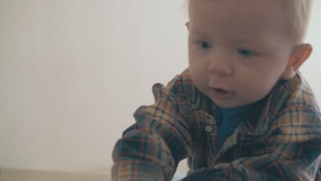 active-boy-climbs-up-on-low-table-to-reach-tv-remote-control