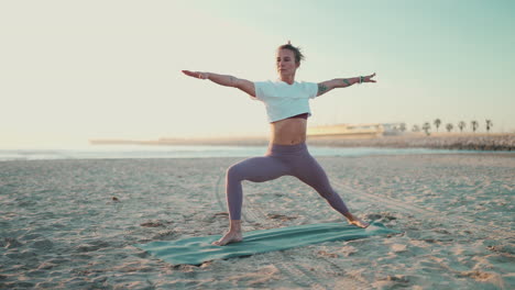 fit woman doing yoga on mat outdoors.