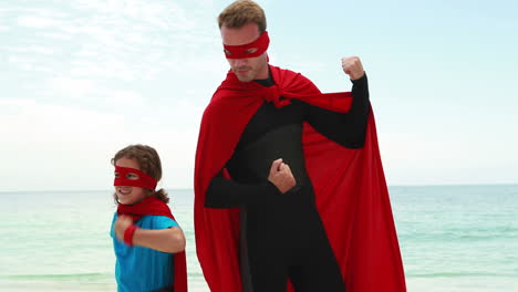 father and son pretending to be superhero