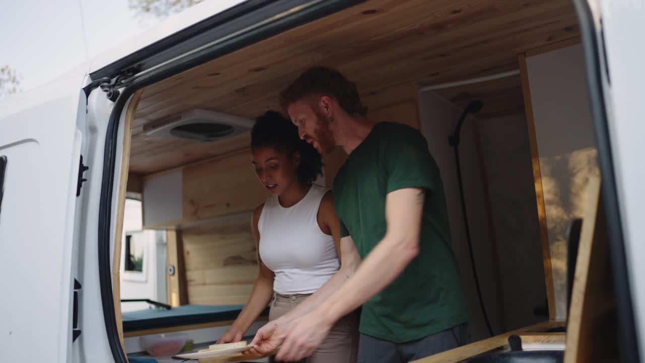 Couple Cooking in a Van