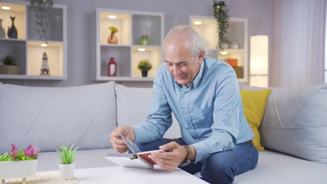 The-old-man-looking-at-the-family-album-is-happy.